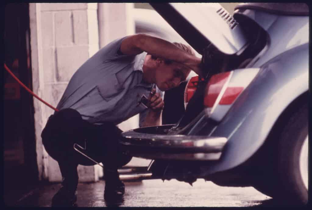 Man fixing car for emissions testing